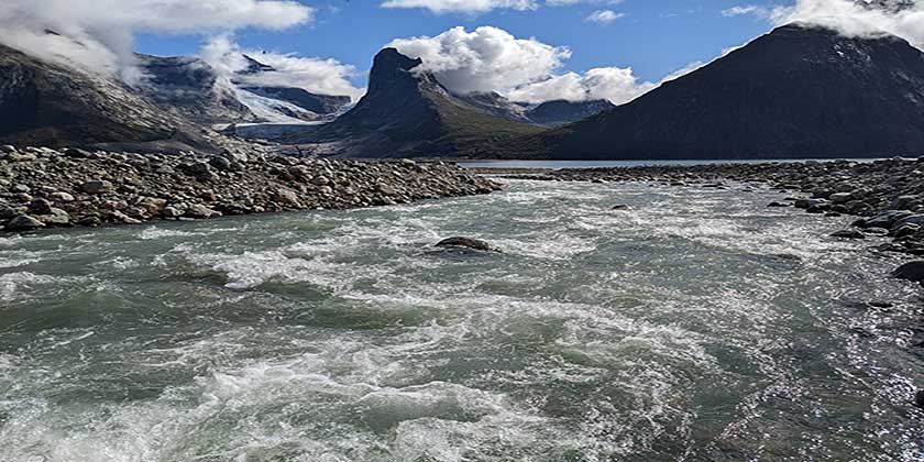 A turbid, glacial-influenced river flowing into the Taermiut Fjord in South Greenland